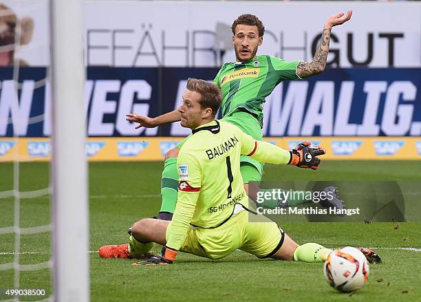 Fabian Johnson of Gladbach scores his team's first goal past goalkeeper Oliver Baumann of Hoffenheim during the Bundesliga match between 1899...