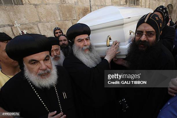 Coptic clergy carry the cascade of Archbishop Anba Abraham, the head of the Coptic Church in the Holy Land during his funeral procession on November...