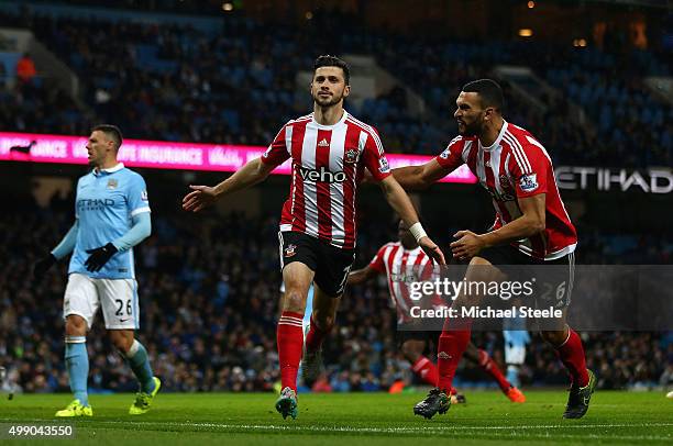 Shane Long of Southampton celebrates scoring his team's first goalwith Steven Caulker during the Barclays Premier League match between Manchester...