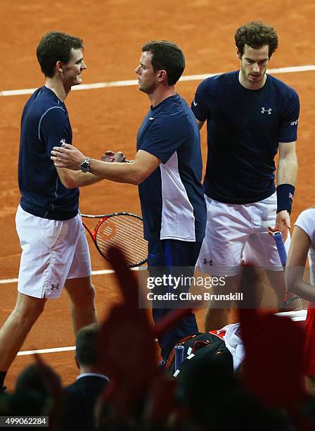 Jamie Murray of Great Britain is congratulated by his team captain Leon Smith after his four set victory with his brotherAndy Murray in their doubles...