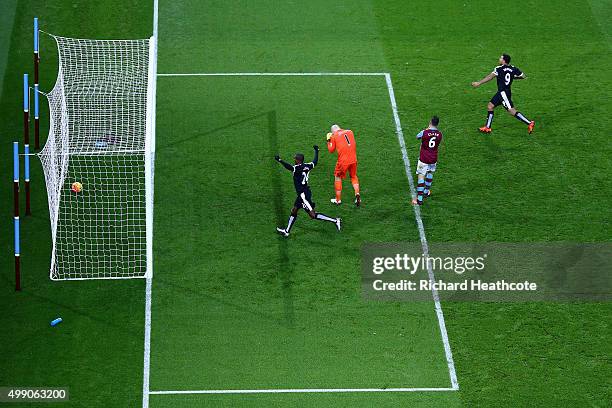 Odion Ighalo and Troy Deeney of Watford celebrate their team's second goal while Aston Villa players show their dejection after Alan Hutton of Aston...