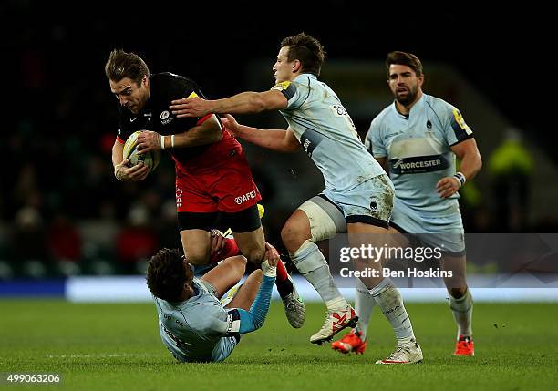 Chris Wylde of Saracens is tackled by Ben Howard and Ryan Mills of Worcester during the Aviva Premiership match between Saracens and Worcester...