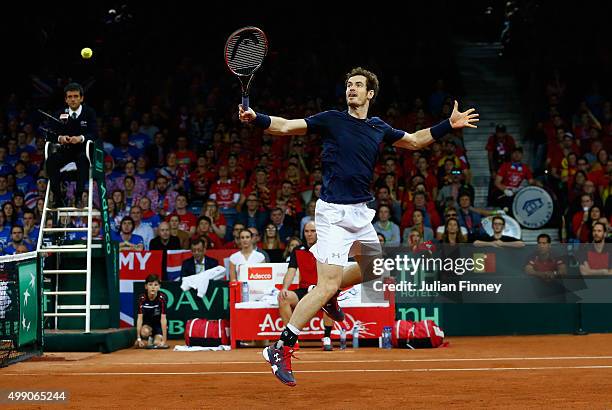 Andy Murray of Great Britain in action with partner Jamie Murray against Steve Darcis and David Goffin of Belgium in the doubles during day two of...