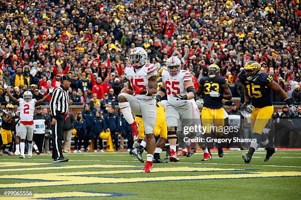 Running back Ezekiel Elliott of the Ohio State Buckeyes celebrates after rushing for a second quarter touchdown against the Michigan Wolverines at...