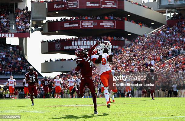 Deon Cain of the Clemson Tigers catches a touchdown pass over Al Harris Jr. #7 of the South Carolina Gamecocks during their game at Williams-Brice...