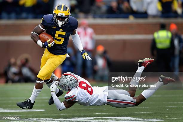 Jabrill Peppers of the Michigan Wolverines eludes the tackle of Gareon Conley of the Ohio State Buckeyes in the first half at Michigan Stadium on...