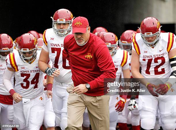 Paul Rhoads leads Iowa State onto the field during the game against the West Virginia Mountaineers on November 28, 2015 at Mountaineer Field in...