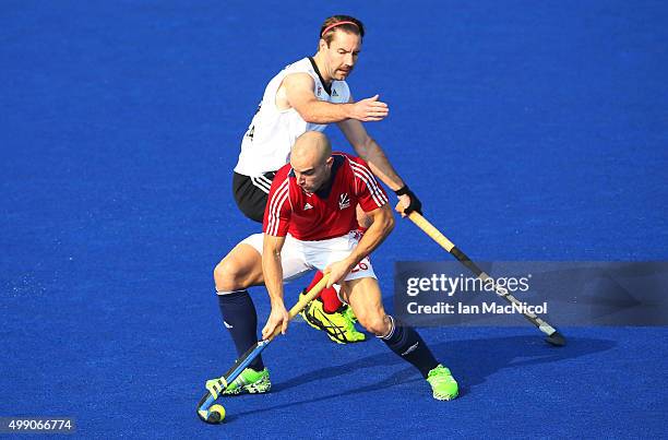 Nick Catlin of Great Britain vies with Richard Hildreth of Canada during the match between Great Britain and Canada on day two of The Hero Hockey...