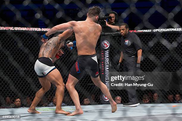 Benson Henderson of the United States of America punches Jorge Masvidal of the United States of America in their welterweight bout during the UFC...