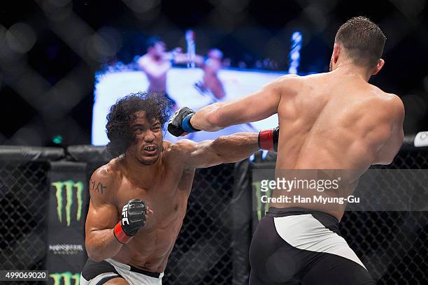 Benson Henderson of the United States of America punches Jorge Masvidal of the United States of America in their welterweight bout during the UFC...