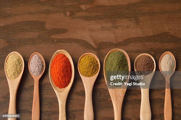 various colorful spices on wooden spoons - cayenne bildbanksfoton och bilder