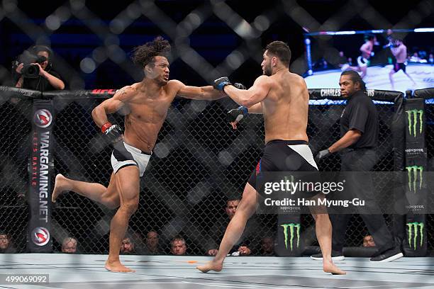 Benson Henderson of the United States of America punches Jorge Masvidal of the United States of America in their welterweight bout during the UFC...