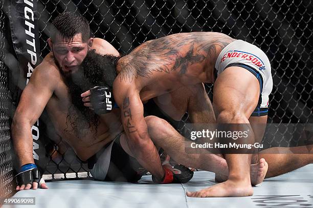 Benson Henderson of the United States of America and Jorge Masvidal of the United States of America grapple for control in their welterweight bout...