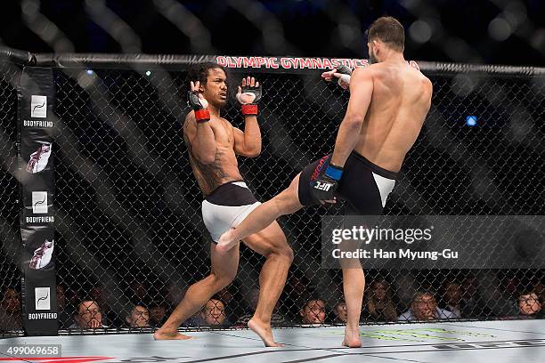 Jorge Masvidal of the United States of America kicks Benson Henderson of the United States of America in their welterweight bout during the UFC Fight...