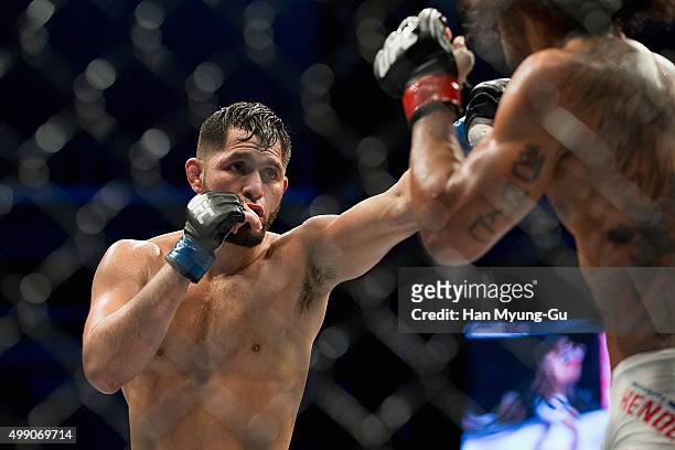 Jorge Masvidal of the United States of America throws a punch at Benson Henderson of the United States of America in their welterweight bout during...