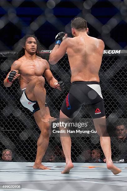 Benson Henderson of the United States of America throws a kick at Jorge Masvidal of the United States of America in their welterweight bout during...