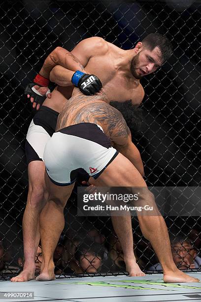 Jorge Masvidal of the United States of America goes for a submission attempt on Benson Henderson of the United States of America in their...