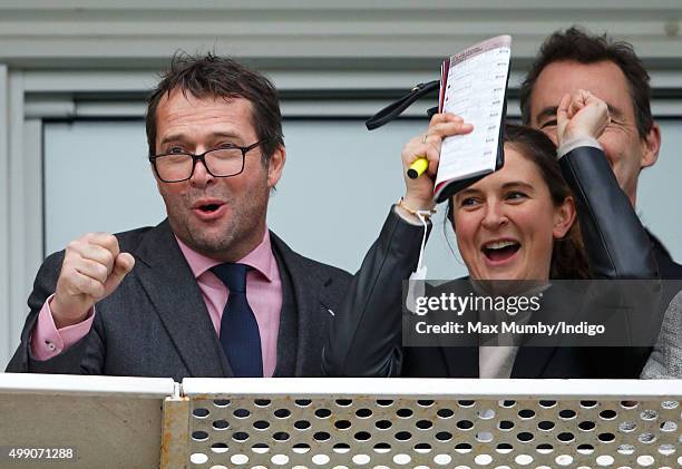 James Purefoy and Jessica Adams watch the racing as they attend the Hennessy Gold Cup horse racing meet at Newbury Racecourse on November 28, 2015 in...