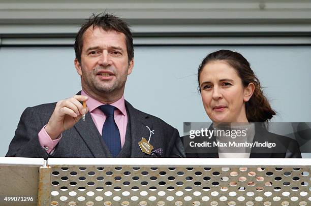 James Purefoy and Jessica Adams watch the racing as they attend the Hennessy Gold Cup horse racing meet at Newbury Racecourse on November 28, 2015 in...