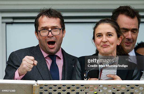 James Purefoy and Jessica Adams watch the racing as they attend the Hennessy Gold Cup horse racing meet at Newbury Racecourse on November 28, 2015 in...
