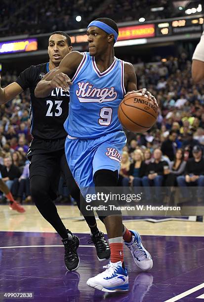 Rajon Rondo of the Sacramento Kings drives towards the basket on Kevin Martin of the Minnesota Timberwolves during an NBA basketball game at Sleep...