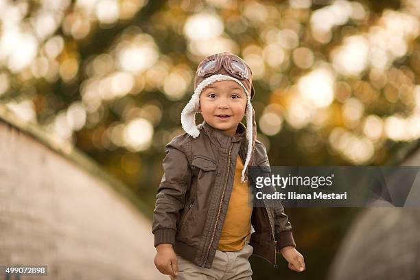 beautiful boy with an aviator hat - fliegermütze stock-fotos und bilder