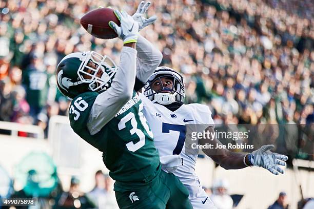 Arjen Colquhoun of the Michigan State Spartans makes an interception in the end zone of a pass intended for Geno Lewis of the Penn State Nittany...