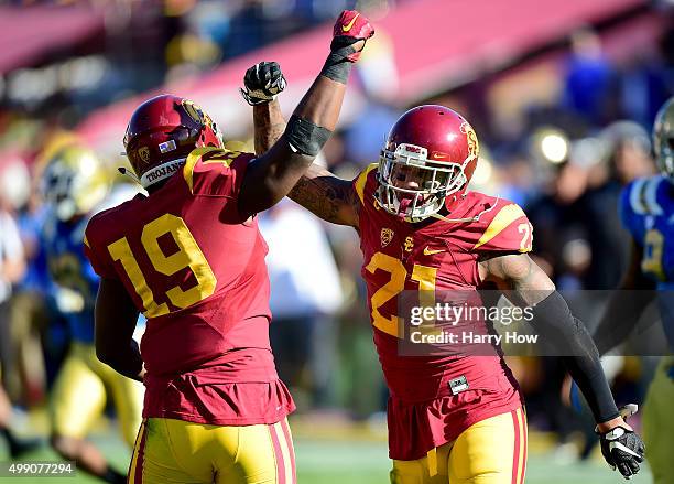 Su'a Cravens of th USC Trojans celebrates his stop of a pass with Michael Hutchings on a UCLA Bruins third down during the second quarter at Los...