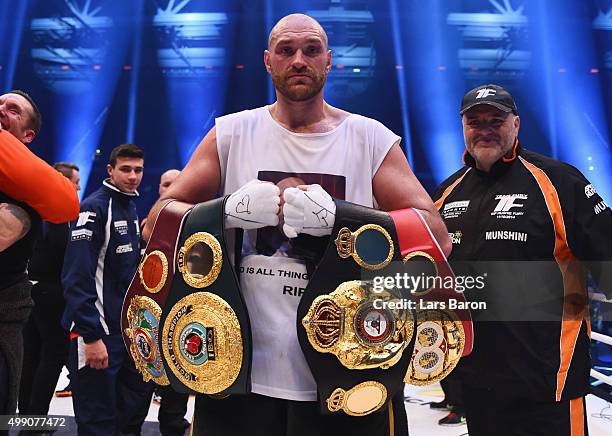 Tyson Fury celebrates with belts as he defeats Wladimir Klitschko to become new World Heavyweight Champion after the IBF IBO WBA WBO Heavyweight...