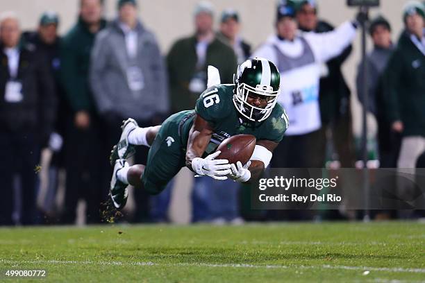 Aaron Burbridge of the Michigan State Spartans attempts to make a catch in the fourth quarter against the Penn State Nittany Lions at Spartan Stadium...
