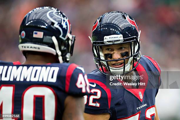 Brian Peters talks with Kurtis Drummond of the Houston Texans on the sidelines during a game against the New York Jets at NRG Stadium on November 22,...