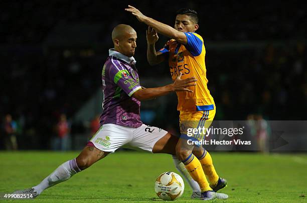 Javier Aquino of Tigres struggles for the ball with Luis Rodriguez of Chiapas during the quarterfinals second leg match between Chiapas and Tigres...