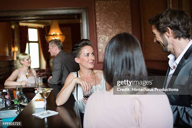 mature adults chatting in a bar - 50s bar stock pictures, royalty-free photos & images