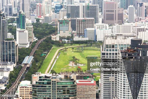 The golf course right in the heart of Bangkok city with the BTS line on its left. Bangkok is Thailand capital city.