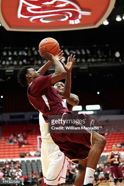 Chris Thomas of the Texas Southern Tigers puts up a shot against Junior Longrus of the Washington State Cougars in the game at Beasley Coliseum on...