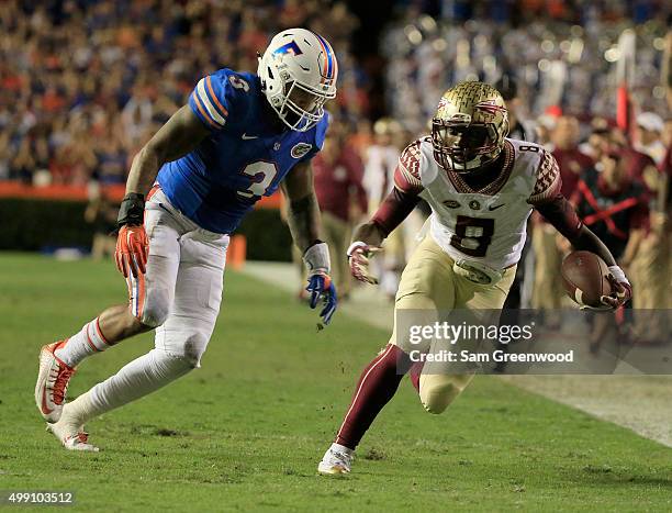 Antonio Morrison of the Florida Gators chses down Kermit Whitfield of the Florida State Seminoles during the game at Ben Hill Griffin Stadium on...