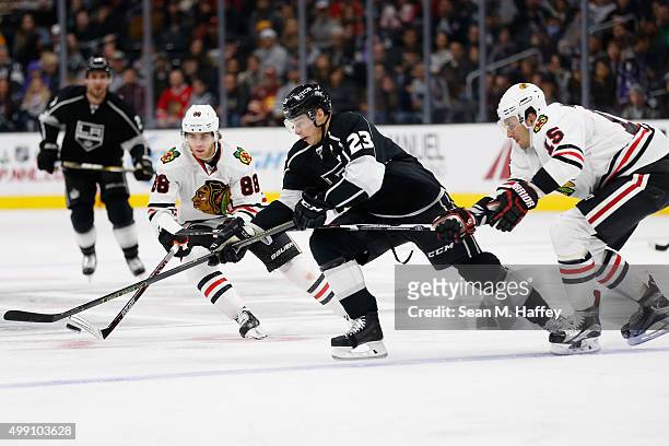 Dustin Brown of the Los Angeles Kings splits the defense of Patrick Kane of the Chicago Blackhawks and Artem Anisimov of the Chicago Blackhawks...
