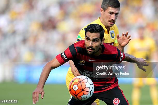 Dimas Delgado of the Wanderers is contests by Nick Montgomery of the Mariners during the round eight A-League match between the Central Coast...