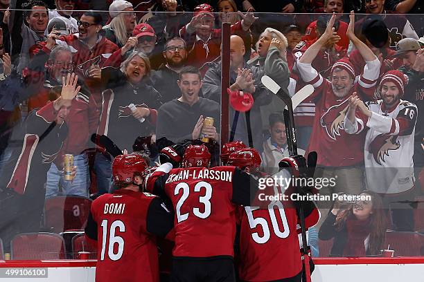 Max Domi, Oliver Ekman-Larsson and Antoine Vermette of the Arizona Coyotes celebrate with Mikkel Boedker after Boedker scored a hat trick goal...