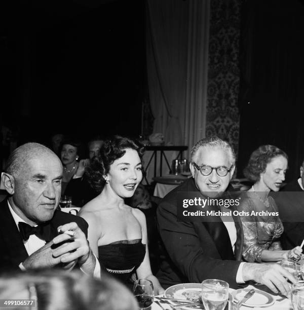 Sam Goldwyn, Jennifer Jones and David O.Selznick attend a dinner in Los Angeles, California.