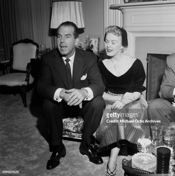 Actress June Haver and husband actor Fred MacMurray attend a party in Los Angeles, California.