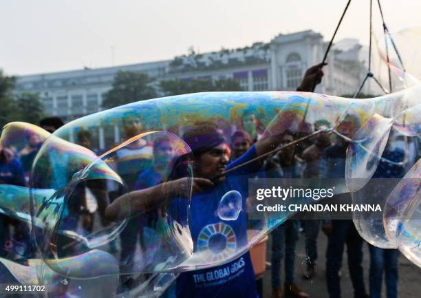 Indian participants perform as they take part in a Global Climate Walk in New Delhi on November 29, 2015. Some 150 leaders including US President...