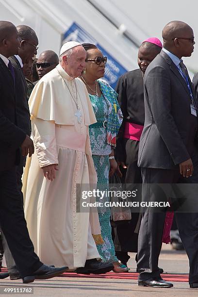 Pope Francis walks after being welcomed by interim leader of the Central African Republic, Catherine Samba Panza after landing in Bangui on November...