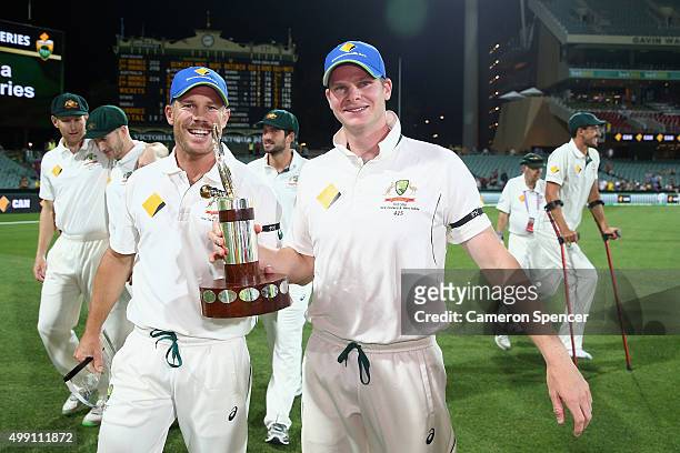 David Warner of Australia and Steve Smith of Australia celebrate with the Trans-tasman trophy after winning the series 2-0 during day three of the...
