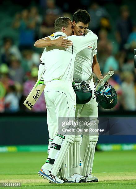 Peter Siddle and Mitchell Starc of Australia hug after winning the third test during day three of the Third Test match between Australia and New...