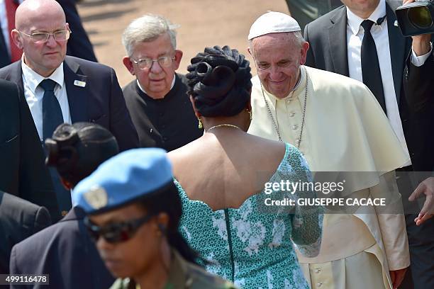 Pope Francis is welcomed by interim leader of the Central African Republic, Catherine Samba Panza as he arrives at the State House in Bangui on...