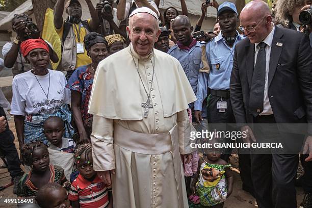 Pope Francis visits an internally displaced people camp at St. Saviour parish in Bangui on November 29, 2015. Pope Francis arrived as "a pilgrim of...