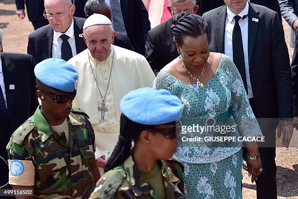 Pope Francis is welcomed by interim leader of the Central African Republic, Catherine Samba Panza as he arrives at the State House in Bangui on...