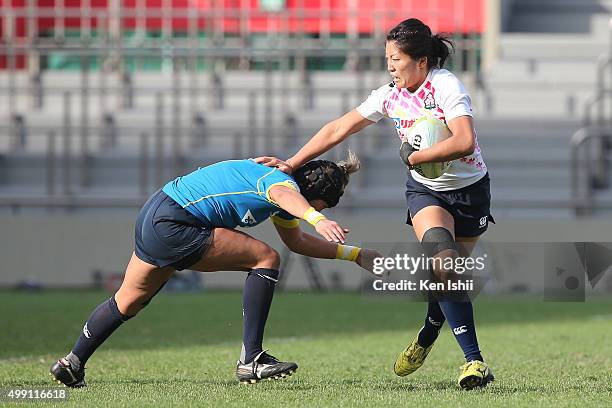 Aya Takeuchi of Japan hands off during the World Sevens Asia Olympic Qualification match between Japan and Kazakhstan at Prince Chichibu Stadium on...