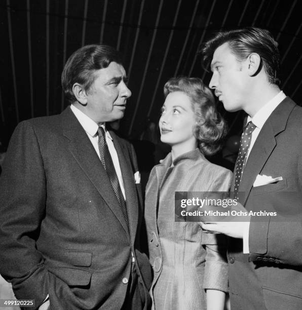 Actor Laurence Harvey with Robert Newton and Norma Brooks attend a Mike Todd party in Los Angeles, California.